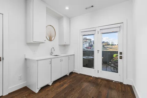 a spacious bathroom with a double vanity sink and a mirror
