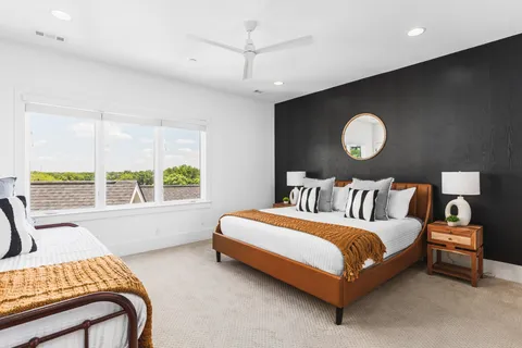 a bedroom with a bed lamp and window