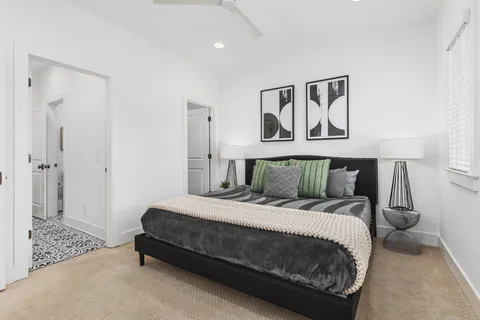 a bedroom with a bed and painting on the wall