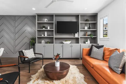 a living room with furniture and a book shelf