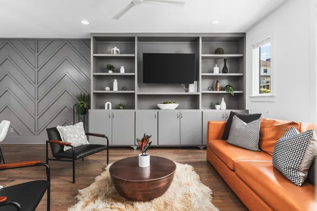 a living room with furniture and a book shelf