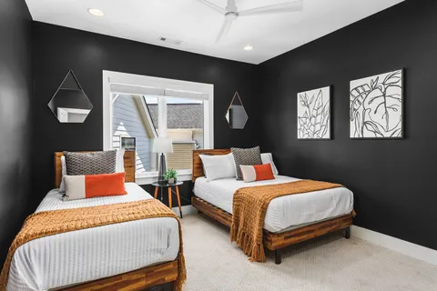 a bedroom with two beds and painting on the wall