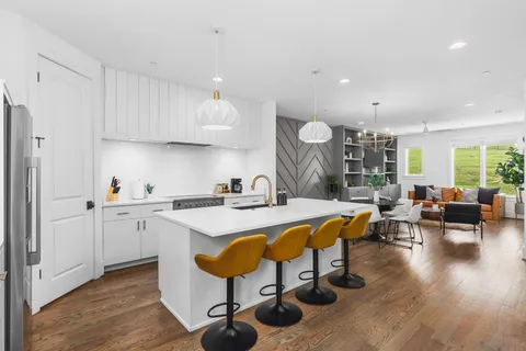 a large white kitchen with a large window