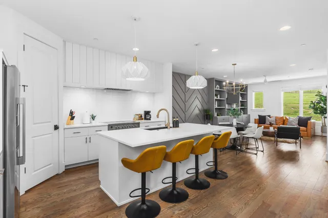 a large white kitchen with a large window