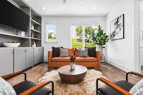 a living room with furniture and a potted plant