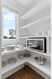 a kitchen with a sink and a stove with wooden floor