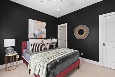 a bedroom with a bed and a painting on the wall