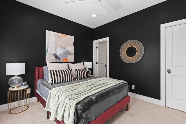 a bedroom with a bed and a painting on the wall