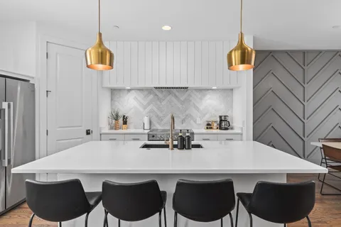 a kitchen with a table chairs stove and microwave