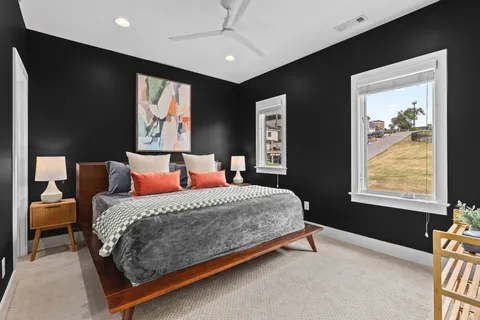 a bed sitting in a bedroom next to a window