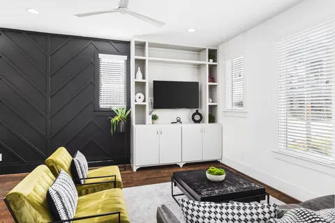 a living room with furniture and a flat screen tv