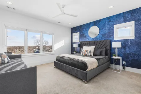 a spacious bedroom with a bed and window