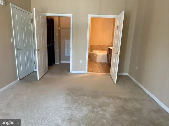 an empty room with closet and a window
