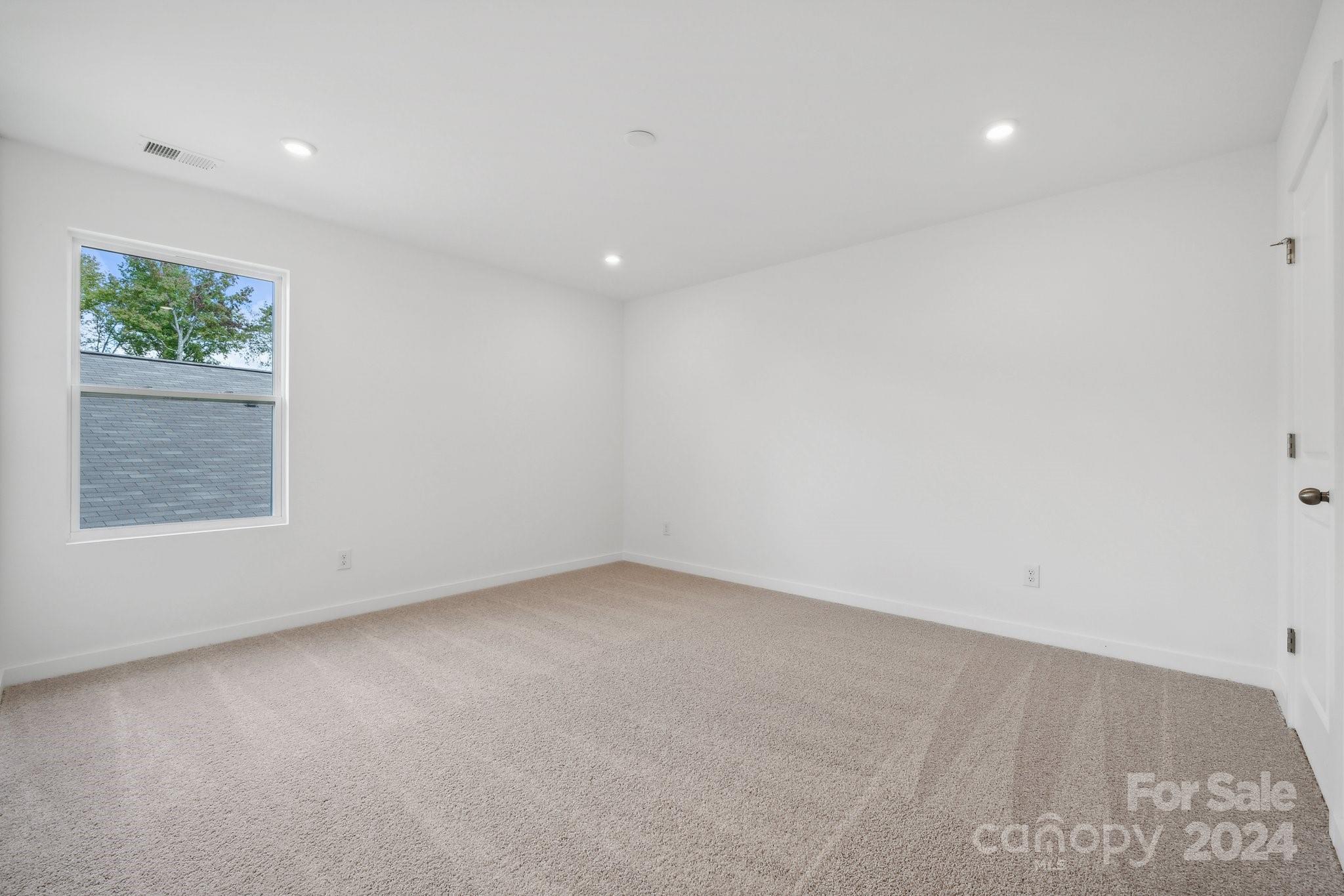 2568 Blue Sky Mdws Drive Monroe, NC 28110 - Photo 11 of 28 an empty room with windows