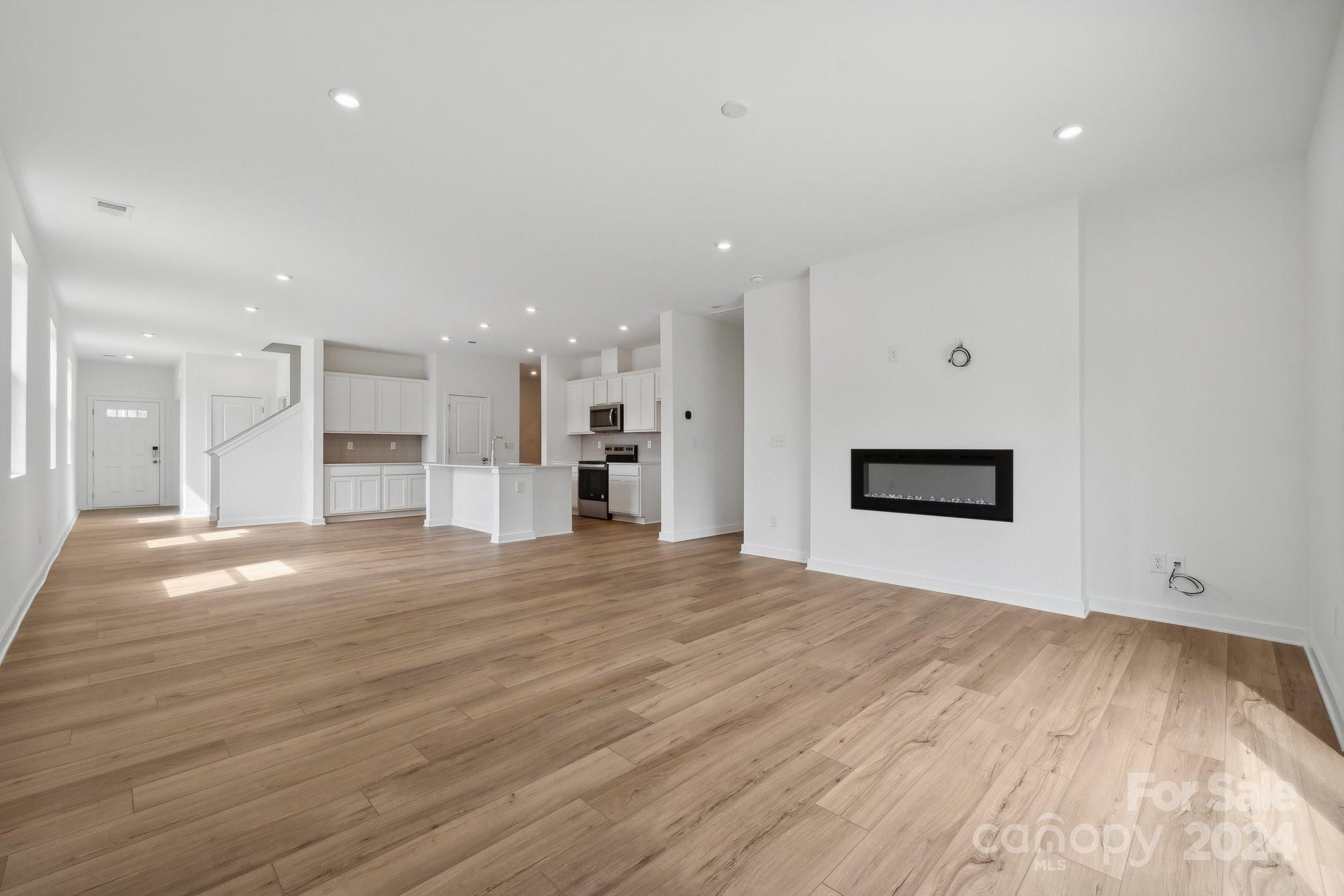 2568 Blue Sky Mdws Drive Monroe, NC 28110 - Photo 3 of 28 a view of an empty room with kitchen and window
