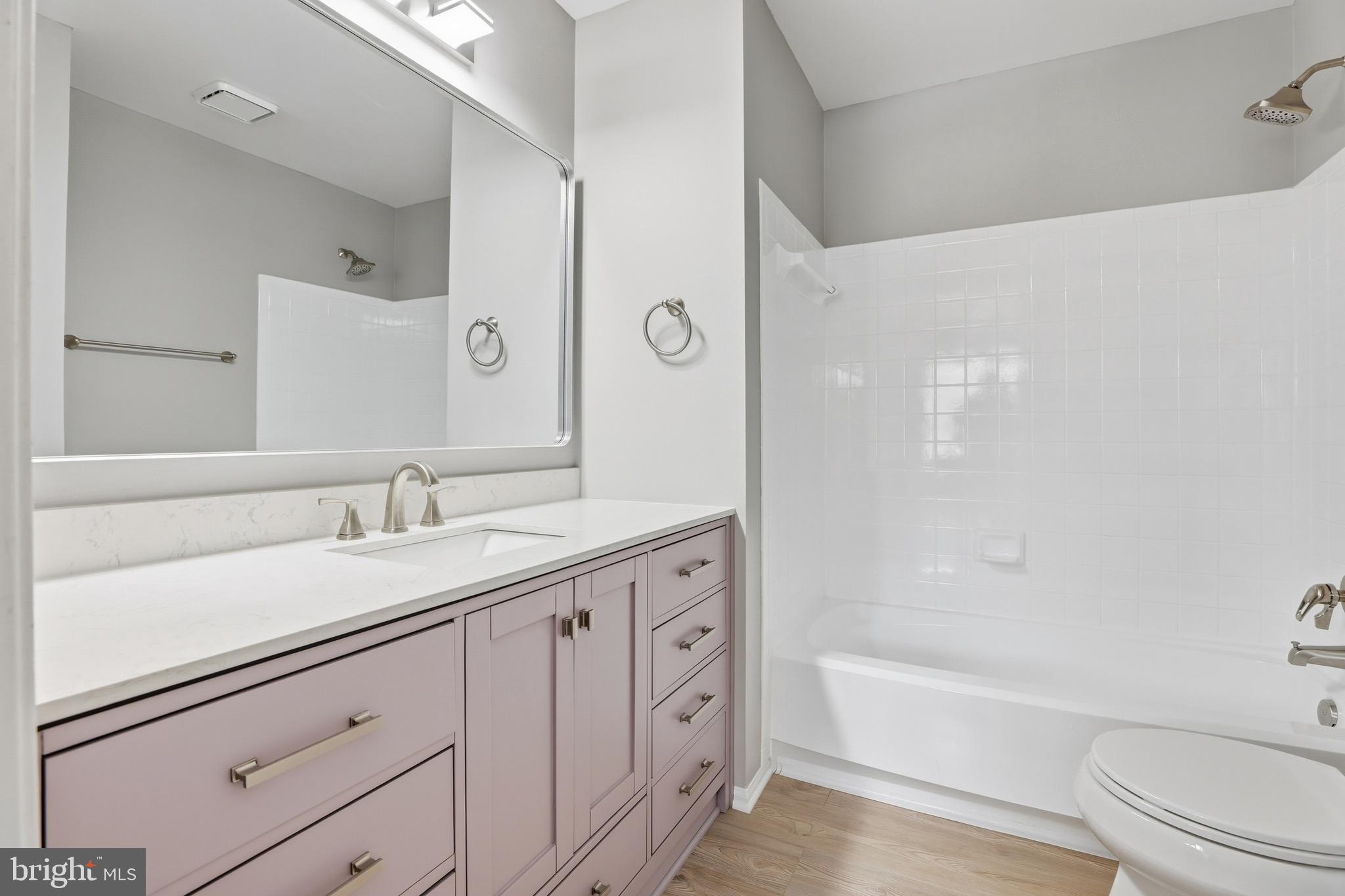 10724 Kitchener Court Bowie, MD 20721 - Photo 18 of 31 a bathroom with a granite countertop sink a toilet and bathtub