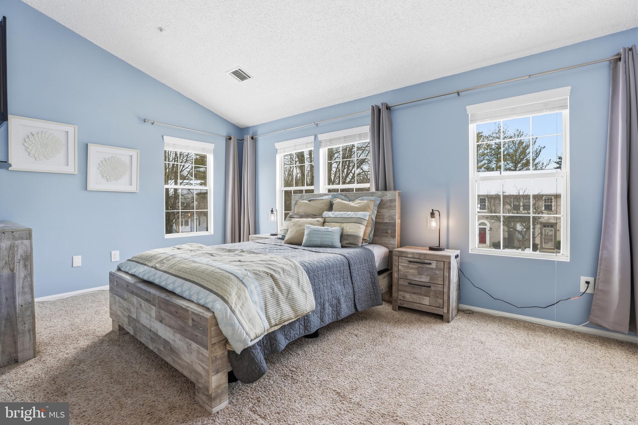 10724 Kitchener Court Bowie, MD 20721 - Photo 19 of 31 a spacious bedroom with a bed and wooden floor