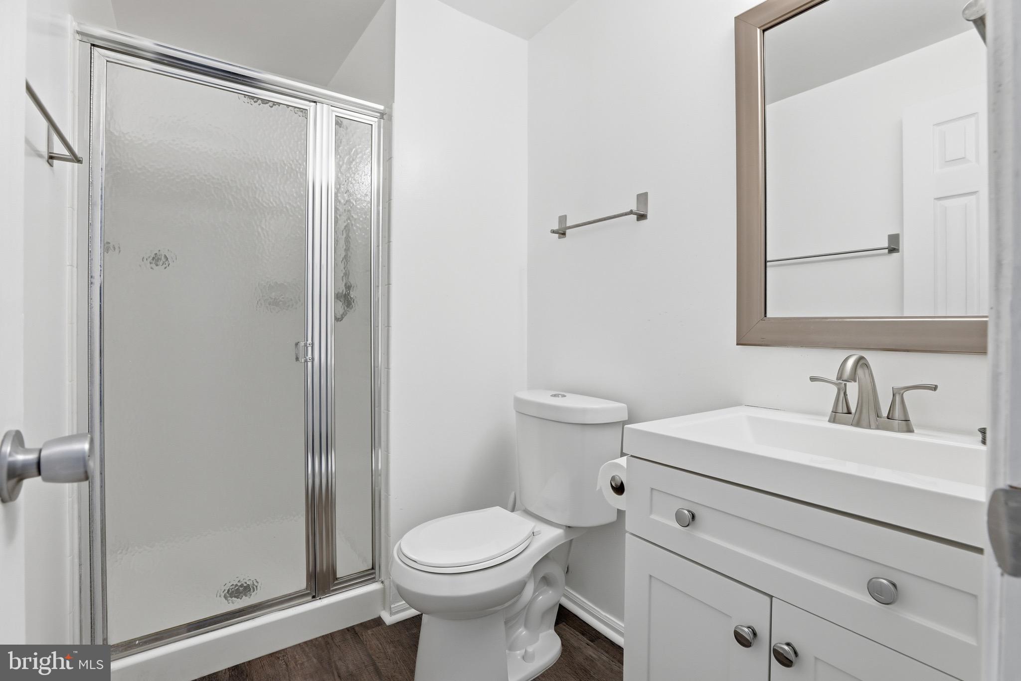 10724 Kitchener Court Bowie, MD 20721 - Photo 24 of 31 a bathroom with a toilet a sink and a mirror