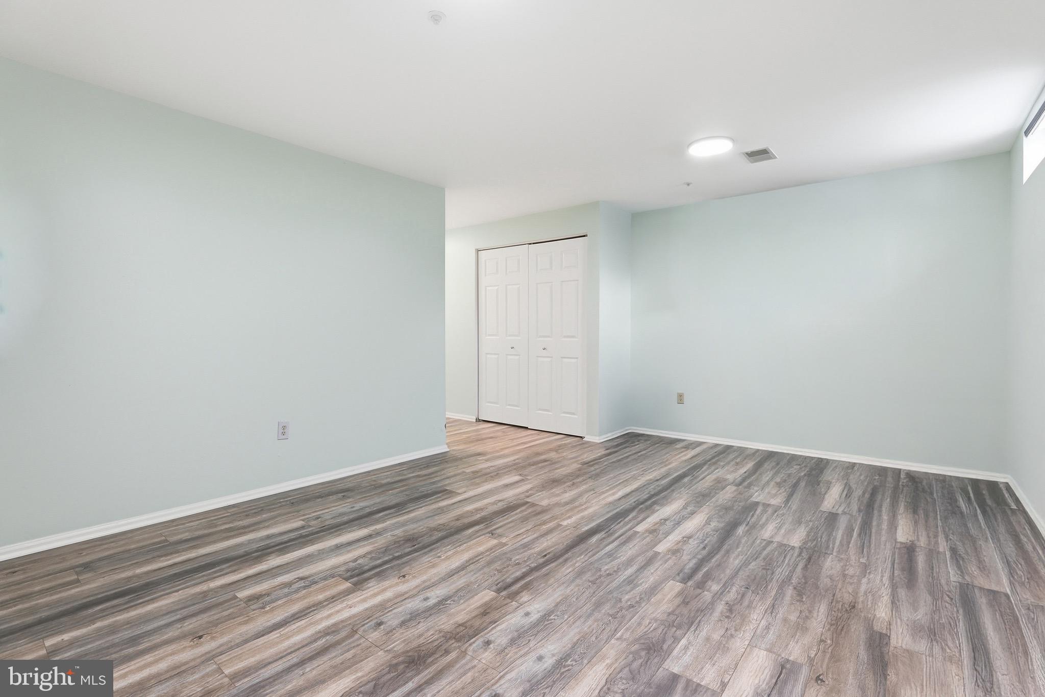 10724 Kitchener Court Bowie, MD 20721 - Photo 27 of 31 a view of an empty room with wooden floor and a window
