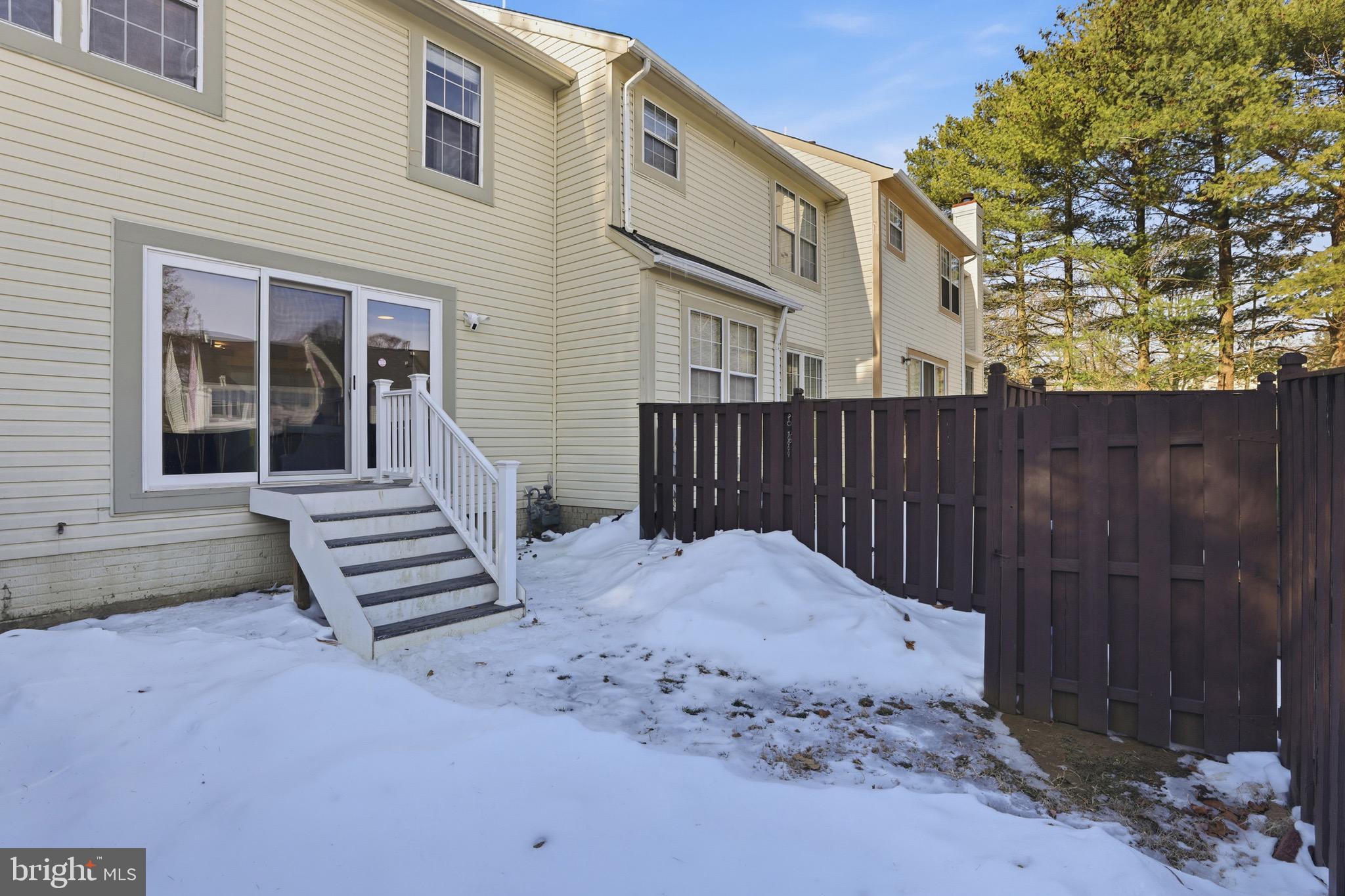 10724 Kitchener Court Bowie, MD 20721 - Photo 29 of 31 a backyard of a house with wooden fence and a porch