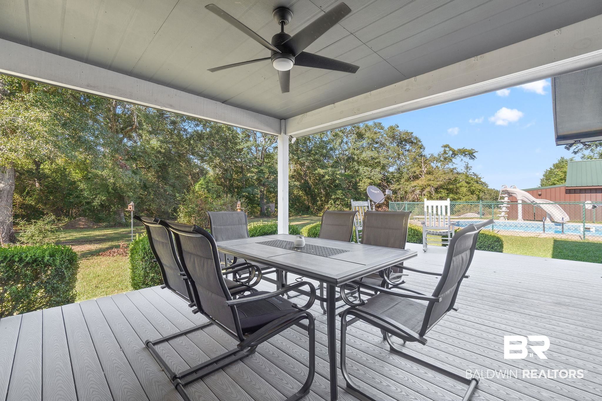27300 C R Watson Road Robertsdale, AL 36567 - Photo 23 of 35 Wooden terrace featuring a pool and ceiling fan