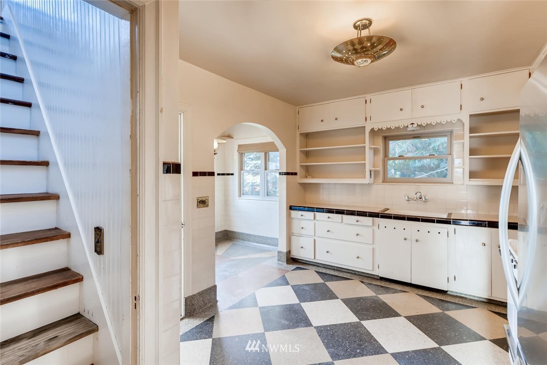 1523 Lake Avenue South Renton, WA 98055 - Photo 7 of 27 a kitchen with granite countertop white cabinets and appliances
