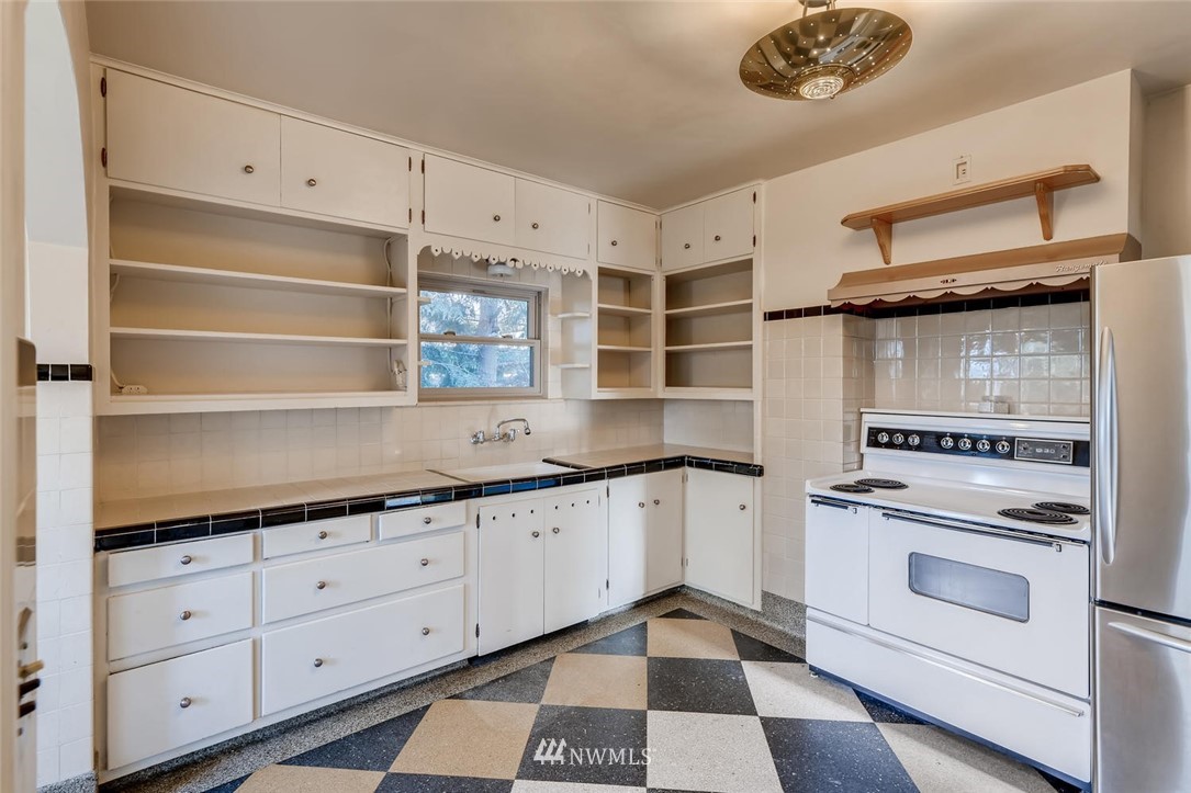 1523 Lake Avenue South Renton, WA 98055 - Photo 8 of 27 a kitchen with granite countertop white cabinets and white appliances