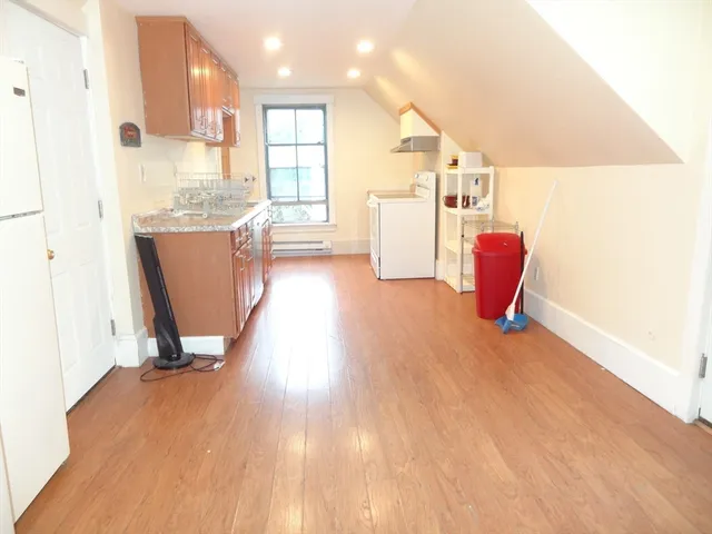 a view of kitchen with furniture and wooden floor