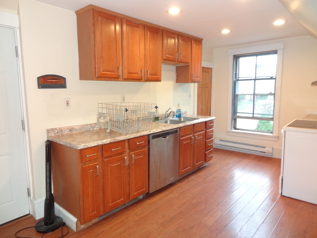 48 Maple Street, Unit 2 Holden, MA 01520 - Photo 4 of 17 a kitchen with a sink a window and cabinets
