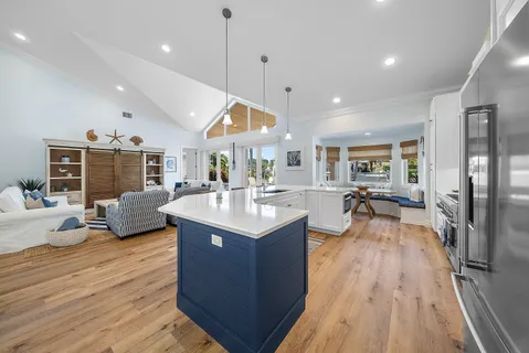 a kitchen with counter top space a sink and wooden floor