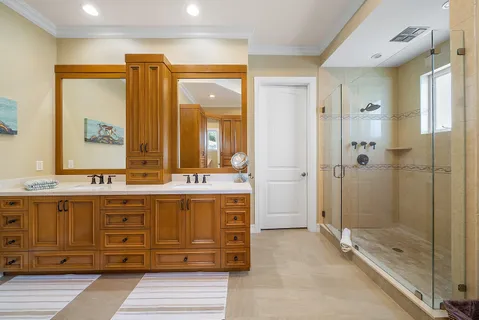 a bathroom with a granite countertop sink mirror and shower