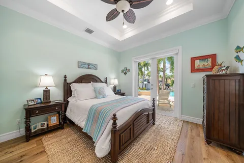 a bedroom with a bed wooden floor and window