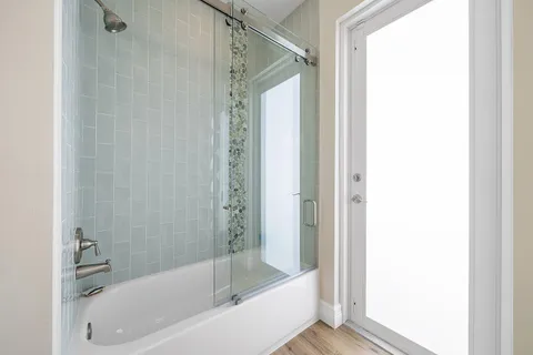 a bathroom with a bathtub and a shower