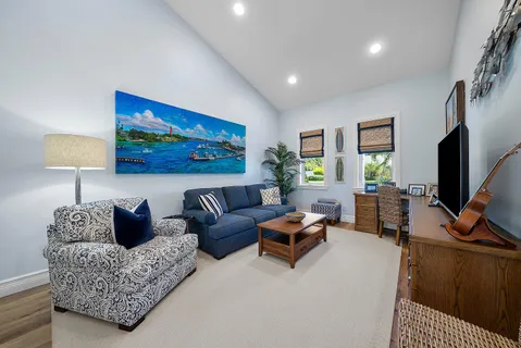 a living room with furniture a lamp and a flat screen tv