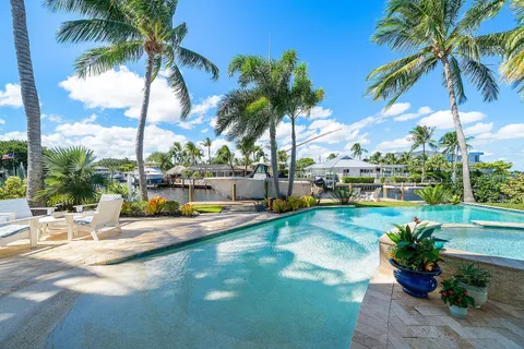 a view of a swimming pool with a table and chairs