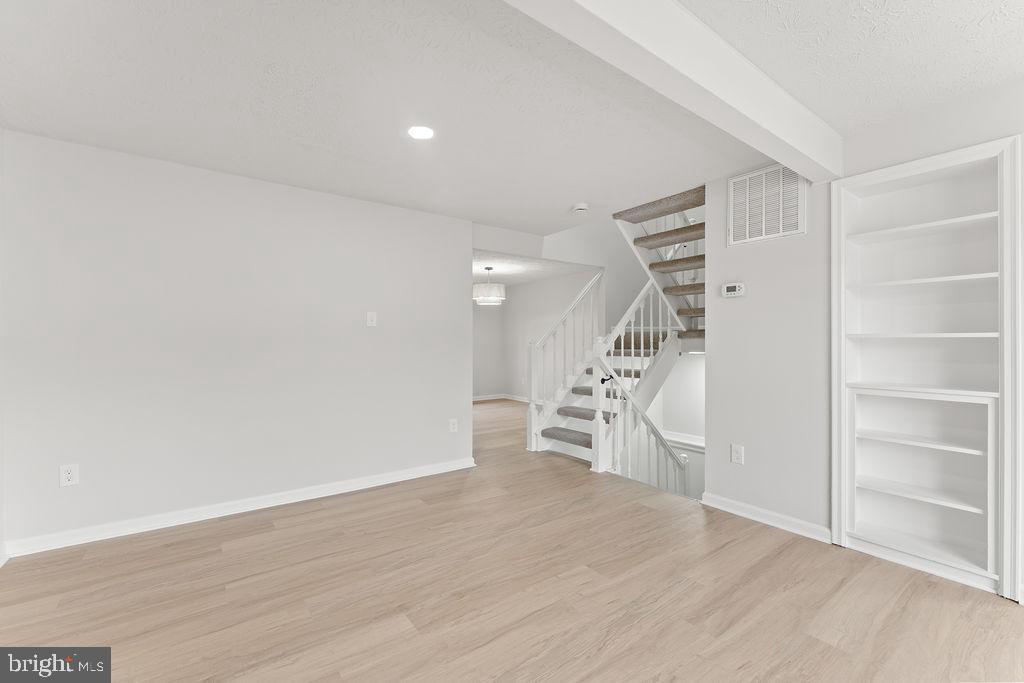 14743 Winding Loop Woodbridge, VA 22191 - Photo 4 of 36 a view of empty room with wooden floor and stairs
