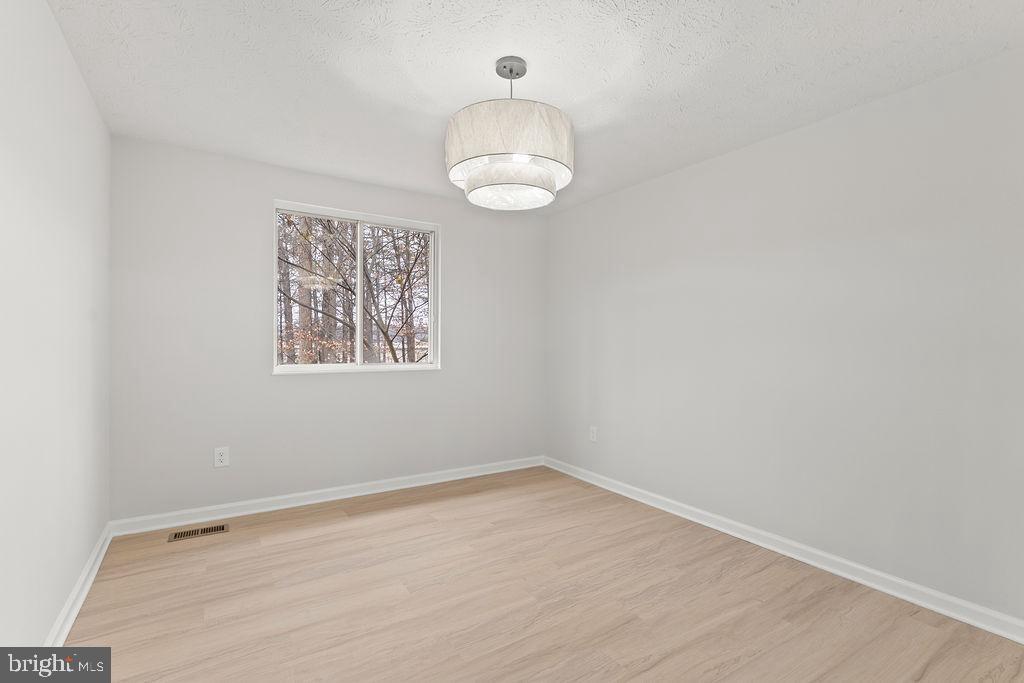 14743 Winding Loop Woodbridge, VA 22191 - Photo 8 of 36 an empty room with a fan