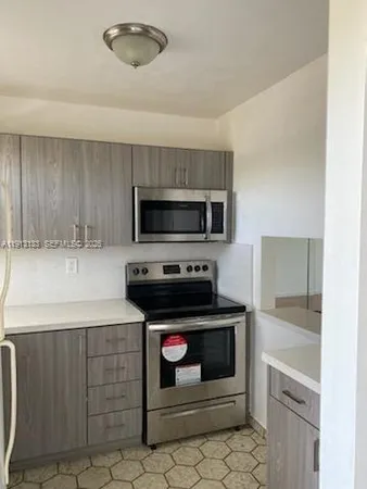 a kitchen with a refrigerator and a sink