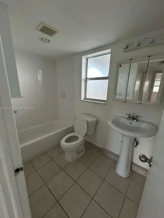 an empty room with an entryway and wooden floor
