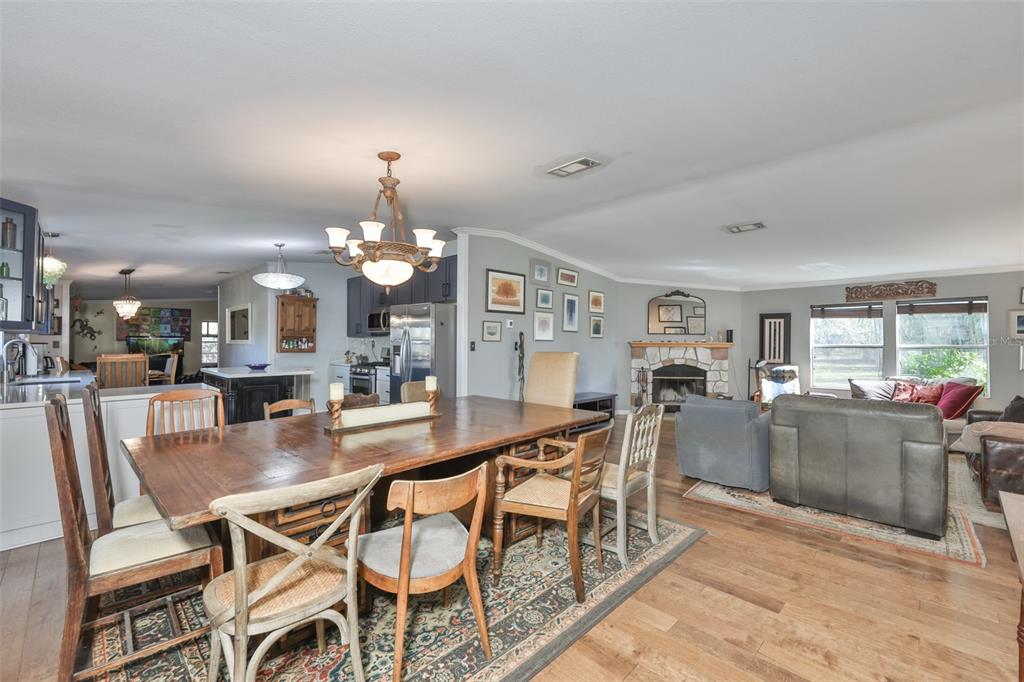20112 Hobbs Road Wimauma, FL 33598 - Photo 15 of 94 a dining area with furniture and chandelier