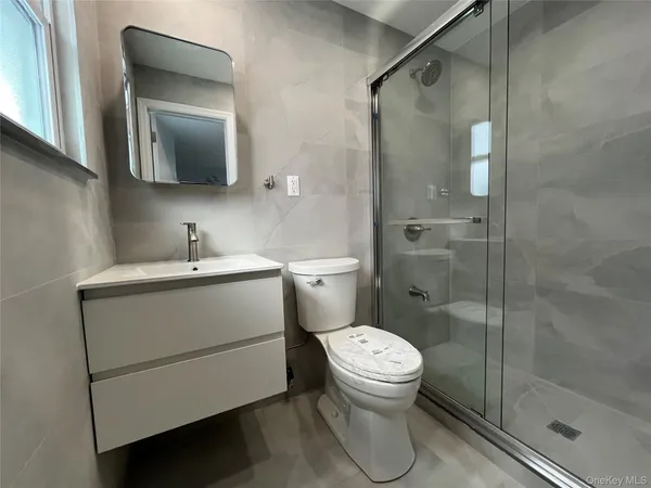 a bathroom with a toilet sink and shower