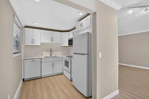a bedroom with a large bed and a potted plant