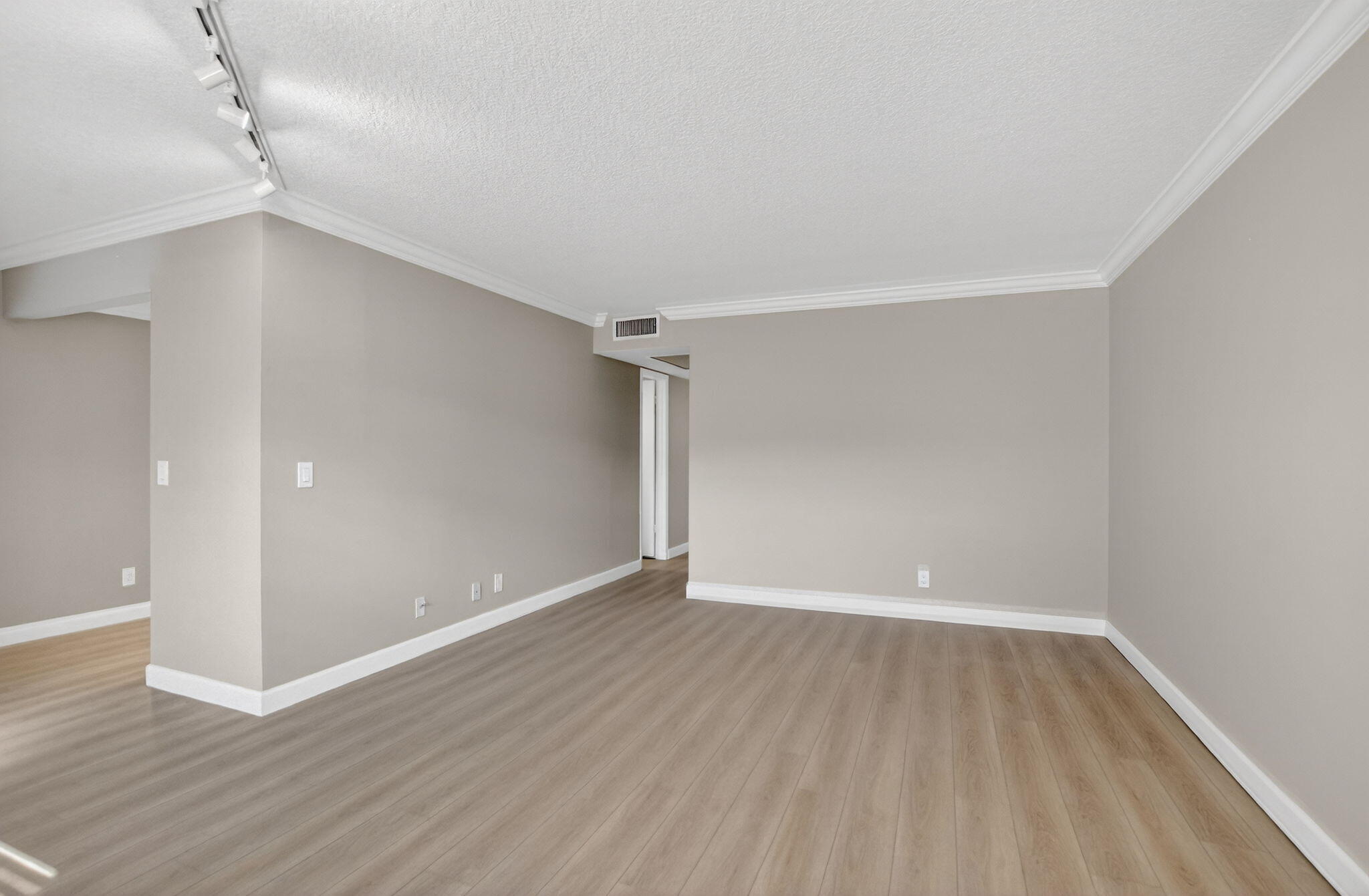 277 Brighton Drive, Unit G Boca Raton, FL 33434 - Photo 9 of 44 a view of an empty room with wooden floor