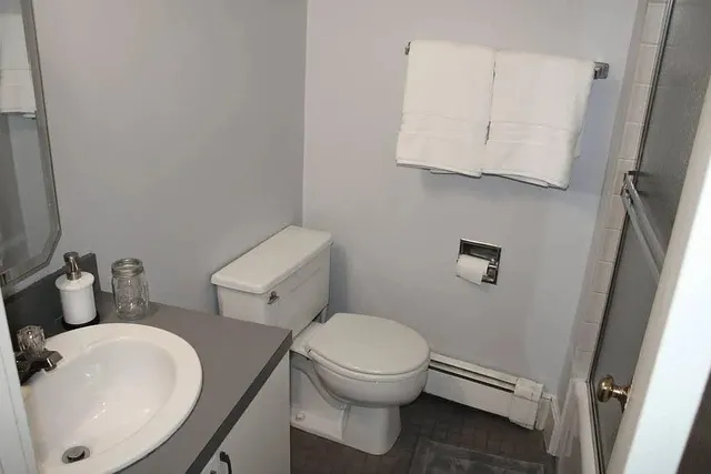 a white toilet sitting next to a bathroom sink