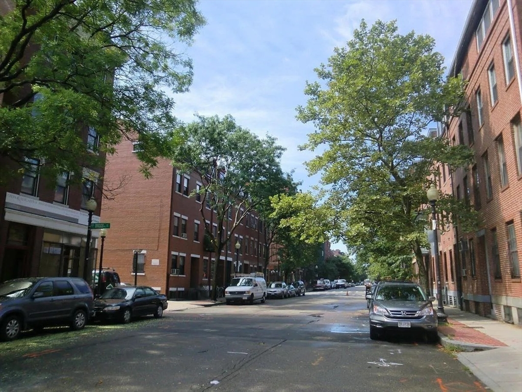 231 Shawmut Avenue, Unit 1 Boston, MA 02118 - Photo 12 of 20 a view of road with card parked on side and retail shops