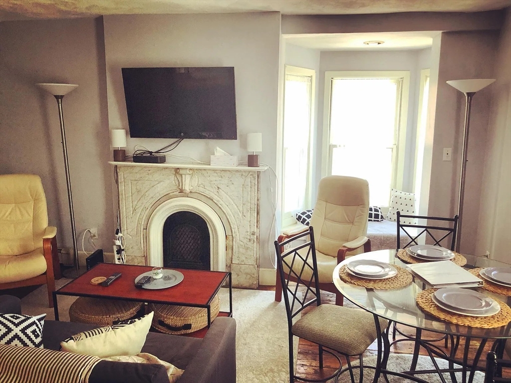 231 Shawmut Avenue, Unit 1 Boston, MA 02118 - Photo 14 of 20 a view of a dining room with furniture window and wooden floor