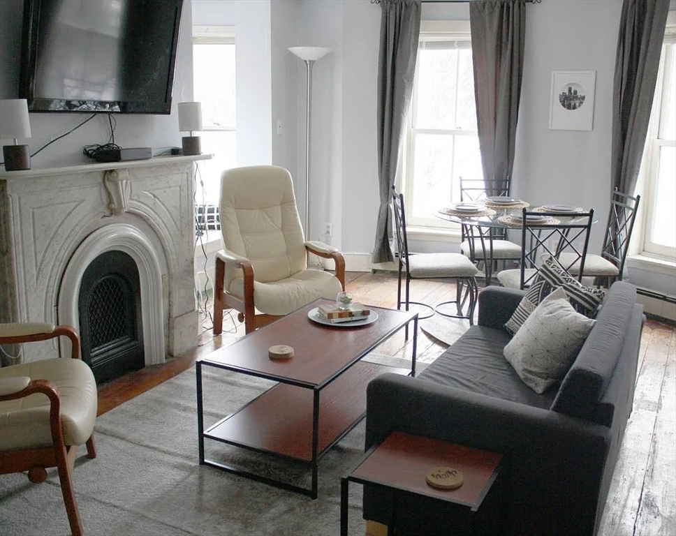 231 Shawmut Avenue, Unit 1 Boston, MA 02118 - Photo 2 of 20 a living room with furniture and a fireplace