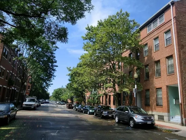 a city street lined with buildings and cars