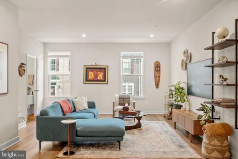 a living room with furniture and wooden floor