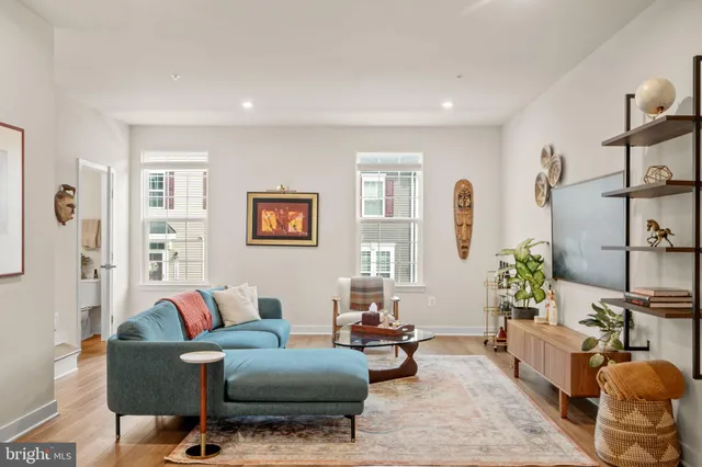 a living room with furniture and wooden floor